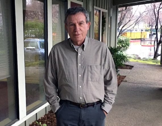 Headshot photo of larry standing outside his office